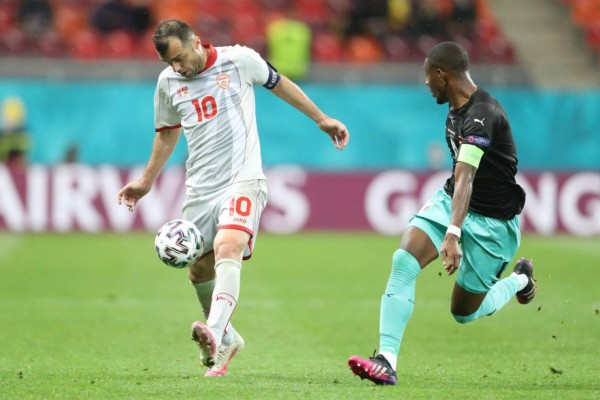 North Macedonia's forward Goran Pandev (L) challenges Austria's defender David Alaba during the UEFA EURO 2020 Group C football match between Austria and North Macedonia at the National Arena in Bucharest on June 13, 2021. (Photo by MARKO DJURICA / POOL / AFP)