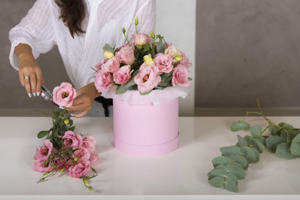 Woman florist making a lovely flower composition in a flower shop