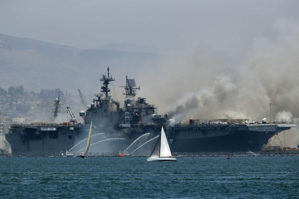 SAN DIEGO, CALIFORNIA - JULY 12: A fire burns on the amphibious assault ship USS Bonhomme Richard at Naval Base San Diego on July 12, 2020 in San Diego, California. There was an explosion on board the ship with multiple injuries reported. Sean M. Haffey/Getty Images/AFP== FOR NEWSPAPERS, INTERNET, TELCOS & TELEVISION USE ONLY ==