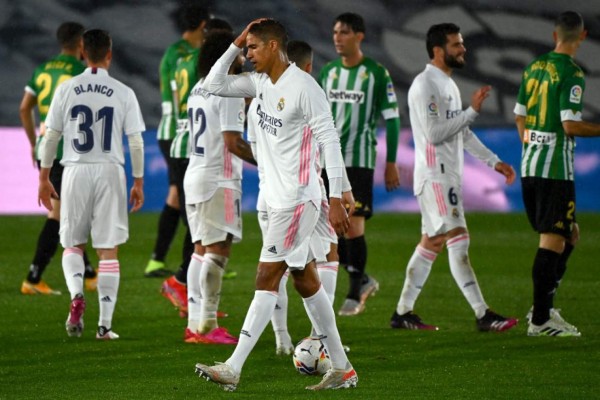 Real Madrid's French defender Raphael Varane touches his head at the end of the Spanish League football match between Real Madrid CF and Real Betis at the Alfredo di Stefano stadium in Valdebebas, on the outskirts of Madrid, on April 24, 2021. (Photo by GABRIEL BOUYS / AFP)