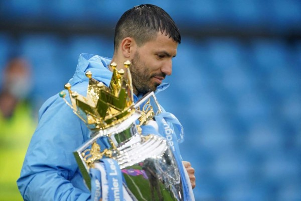 Manchester City's Argentinian striker Sergio Aguero holds the Premier League trophy during the award ceremony after the English Premier League football match between Manchester City and Everton at the Etihad Stadium in Manchester, north west England, on May 23, 2021. (Photo by Dave Thompson / POOL / AFP) / RESTRICTED TO EDITORIAL USE. No use with unauthorized audio, video, data, fixture lists, club/league logos or 'live' services. Online in-match use limited to 120 images. An additional 40 images may be used in extra time. No video emulation. Social media in-match use limited to 120 images. An additional 40 images may be used in extra time. No use in betting publications, games or single club/league/player publications. /