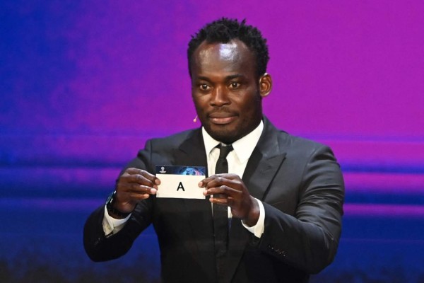 Former Ghanaian international footballer Michael Essien displays the slip of the group A during the draw for the UEFA Champions League football tournament in Istanbul on August 26, 2021. (Photo by OZAN KOSE / AFP)