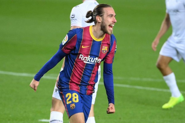 Barcelona's Spanish defender Oscar Mingueza celebrates after scoring a goal during the Spanish League football match between Barcelona and SD Huesca at the Camp Nou stadium in Barcelona on March 15, 2021. (Photo by LLUIS GENE / AFP)