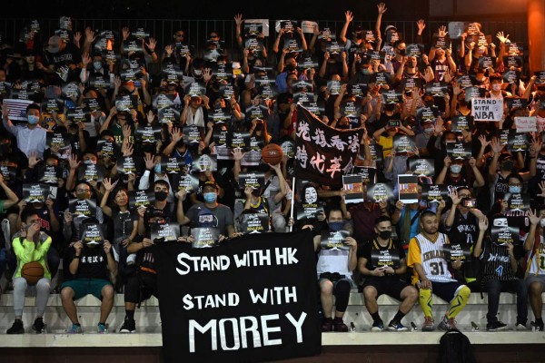 Protesters shout slogans as they hold flyers at the Southorn Playground in Hong Kong on October 15, 2019, during a rally in support of NBA basketball Rockets general manager Daryl Morey and against comments made by Lakers superstar LeBron James. - US basketball superstar LeBron James on October 14, 2019, has sharply criticised a Houston Rockets executive for angering China with a tweet supporting protesters in Hong Kong, saying the executive was 'misinformed' and should have kept his mouth shut. (Photo by Anthony WALLACE / AFP)
