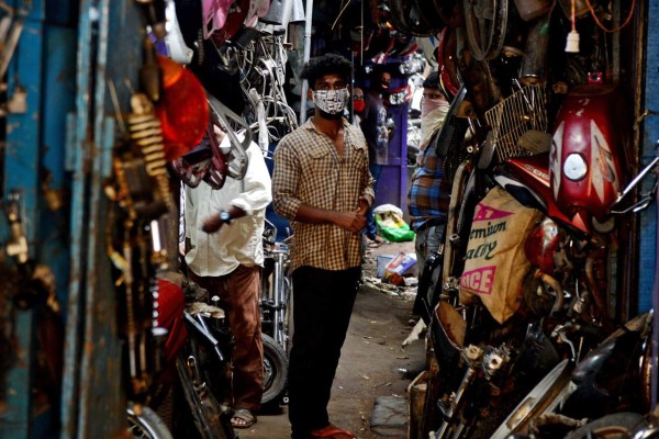 Shopkeepers wait for customers at a second hand automobile spare market after the government eased a nationwide lockdown imposed as a preventive measure against the spread of the COVID-19 coronavirus, in Chennai on July 6, 2020. - India announced on July 6 that it has nearly 700,000 coronavirus cases, taking it past Russia to become the third-hardest-hit nation in the global pandemic. The health ministry said 697,358 cases had now been recorded, a rise of 24,000 in 24 hours, while Russia has just over 681,000. (Photo by Arun SANKAR / AFP)
