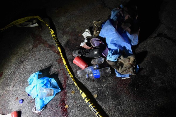 Footwear belonging to some of the eighteen victims killed after a truck ran them over are seen on a road in Nahuala municipality in Solola Departament, about 160kms west of Guatemala City on March 28, 2019. - A truck driver barreled into a group of indigenous Guatemalans on March 28, killing 18 before fleeing the scene as police began a manhunt. (Photo by JOHAN ORDONEZ / AFP)