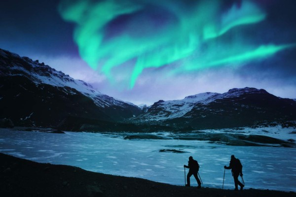 Hikers under the northern lights in Iceland.