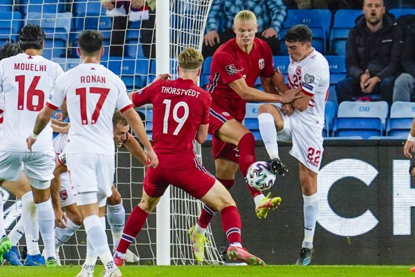 Norway's forward Erling Braut Haaland and Gibraltar's midfielder Graeme Torrilla (R) vie for the ball during the FIFA World Cup Qatar 2022 qualification Group G football match between Norway and Gibraltar in Oslo, on September 7, 2021. (Photo by Lise Åserud / NTB / AFP) / Norway OUT
