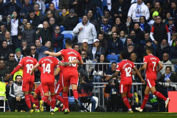 Girona's players celebrate their second goal during the Spanish League football match between Real Madrid and Girona at the Santiago Bernabeu stadium in Madrid on February 17, 2019. (Photo by GABRIEL BOUYS / AFP)