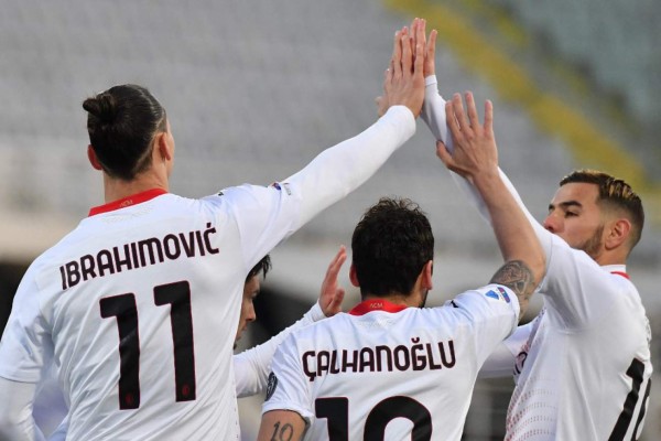 AC Milan's Swedish forward Zlatan Ibrahimovic celebrates with AC Milan's French defender Theo Hernandez (R) after opening the scoring during the Italian Serie A football match Fiorentina vs AC Milan on March 21, 2021 at the Artemio-Franchi stadium in Florence. (Photo by Tiziana FABI / AFP)