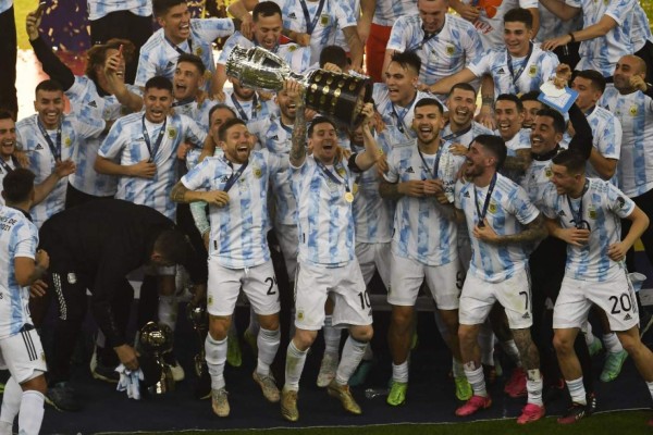Argentina's Lionel Messi holds the trophy after winning the Conmebol 2021 Copa America football tournament final match against Brazil at Maracana Stadium in Rio de Janeiro, Brazil, on July 10, 2021. (Photo by MAURO PIMENTEL / AFP)
