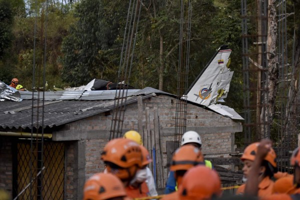 Rescuers work at the site where a plane crashed at the Junin neighborhood in Popayan, southwestern Colombia, on September 15, 2019. - At least seven people were killed and another three injured when a small plane crashed in southwestern Colombia on Sunday, a firefighter said. (Photo by Luis ROBAYO / AFP)