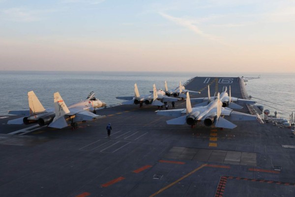 (FILES) This file photo taken on December 10, 2016 taken on an undisclosed date in December 2016 shows Chinese J-15 fighter jets waiting on the deck of the Liaoning aircraft carrier during military drills in the Bohai Sea, off China's northeast coast. China continues to arm itself faster than other countries to the point of moving towards near parity with the West in some military areas, according to the annual report of the International Institute for Strategic Studies (IISS) released on February 14, 2017. / AFP PHOTO / STR / China OUT