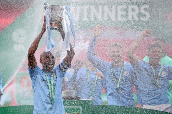 Manchester City's Brazilian midfielder Fernandinho lifts the winners trophy after the English League Cup final football match between Manchester City and Tottenham Hotspur at Wembley Stadium, northwest London on April 25, 2021. - Manchester City claimed a fourth consecutive League Cup on Sunday with a dominant display to beat Tottenham 1-0 in front of 8,000 fans at Wembley. (Photo by CARL RECINE / POOL / AFP) / RESTRICTED TO EDITORIAL USE. No use with unauthorized audio, video, data, fixture lists, club/league logos or 'live' services. Online in-match use limited to 120 images. An additional 40 images may be used in extra time. No video emulation. Social media in-match use limited to 120 images. An additional 40 images may be used in extra time. No use in betting publications, games or single club/league/player publications. /