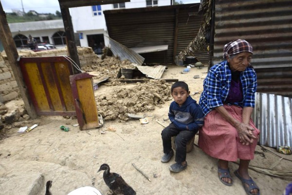Local residents sit amidst damage caused by the earthquake, which mainly hit Mexico, in Tacana municipality, San Marcos departament, Guatemala, on the border with Mexico, 320 km from Guatemala City, on September 8, 2017. Mexico was severely jolted overnight by an 8.2 magnitude earthquake - the most powerful in a century - which was also felt in much of Guatemala, which borders the southern Mexican state of Chiapas, leaving four people injured and many homes damaged in this Central American country. / AFP PHOTO / JOHAN ORDONEZ