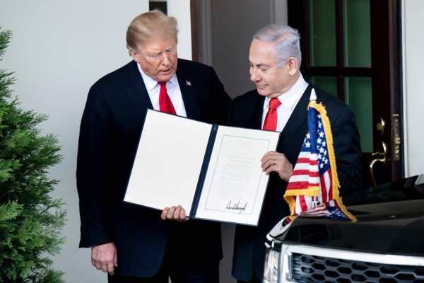 US President Donald Trump (L) and Israel's Prime Minister Benjamin Netanyahu hold up a Golan Heights proclamation outside the West Wing after a meeting in the the White House March 25, 2019 in Washington, DC. - US President Donald Trump on Monday signed a proclamation recognizing Israeli sovereignty over the disputed Golan Heights, a border area seized from Syria in 1967. 'This was a long time in the making,' Trump said alongside Israeli Prime Minister Benjamin Netanyahu in the White House. US recognition for Israeli control over the territory breaks with decades of international consensus. (Photo by Brendan Smialowski / AFP)