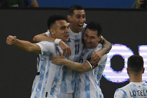 Argentina's Angel Di Maria (C) celebrates with Lautaro Martinez (L) and Lionel Messi after scoring against Brazil during their Conmebol 2021 Copa America football tournament final match at the Maracana Stadium in Rio de Janeiro, Brazil, on July 10, 2021. (Photo by MAURO PIMENTEL / AFP)