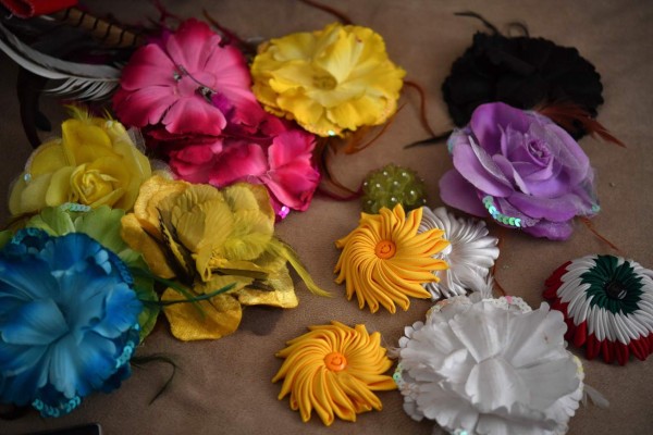 View of Pachuco style accesories at the house of a Pachuco in Tepito neighborhood in Mexico City on August 22, 2017. Wearing their feathered hats, colorful tank tops, gold chains on the lapel and patent leather shoes, the Pachucos - the subculture that characterized Mexican gangs set up in the United States in the 1940s - continue to dance to the rhythm of legendary mambo Salons in Mexico. / AFP PHOTO / YURI CORTEZ / TO GO WITH AFP STORY by YEMELI ORTEGA