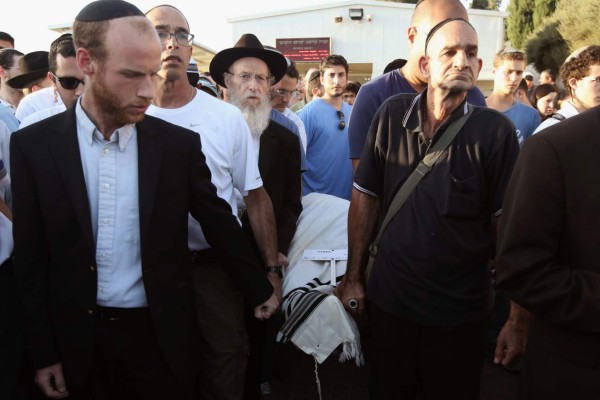 Israelis carry the body of 51-year-old Alon Guverg, who was killed a day earlier when Palestinian attackers shot at a bus, during his funeral procession in Jerusalem on October 14, 2015. The bus attack was the first assault with a gun in Jerusalem in the two-week-old upsurge of Palestinian violence. AFP PHOTO / GALI TIBBON