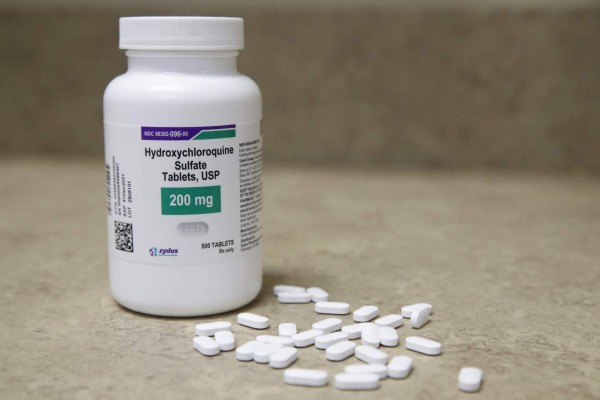 (FILES) In this file photo taken on May 20, 2020 a bottle and pills of Hydroxychloroquine sit on a counter at Rock Canyon Pharmacy in Provo, Utah. - The World Health Organization announced on June 3, 2020 that clinical trials of the drug hydroxychloroquine will resume as it searches for potential coronavirus treatments. On May 25, the WHO announced it had temporarily suspended the trials to conduct a safety review, which has now concluded there is 'no reason' to change the way the trials are conducted. The UN health agency's decision came after a study published in The Lancet medical journal suggesting the drug could increase the risk of death among COVID-19 patients. (Photo by GEORGE FREY / AFP)