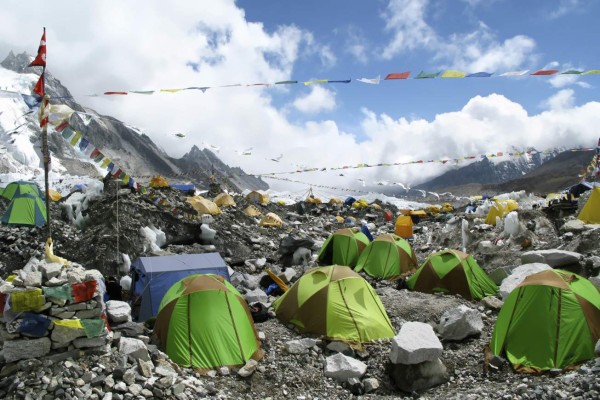 Colorful tents and Tibetan prayer flags at Everest Base Camp, Khumbu Region, Nepal.