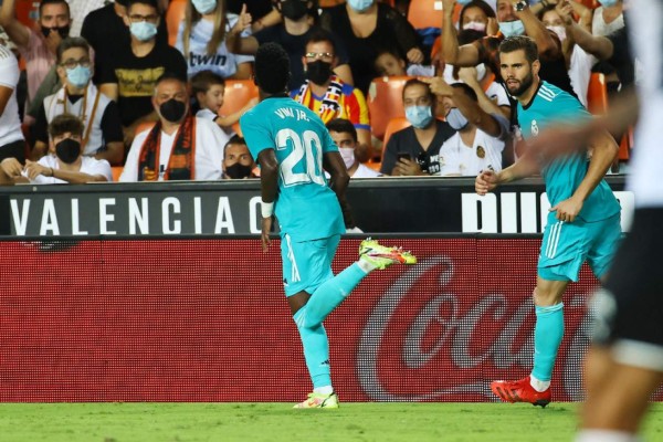 Real Madrid's Brazilian forward Vinicius Junior celebrates his goal during the Spanish League football match between Valencia CF and Real Madrid CF at the Mestalla stadium in Valencia on September 19, 2021. (Photo by JOSE JORDAN / AFP)