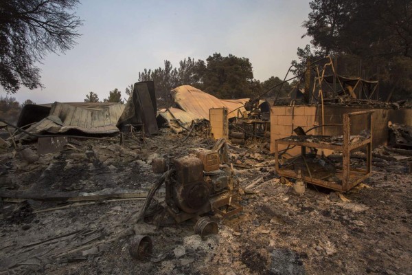 SANTA BARBARA, CA - JULY 09: Structures at Rancho Alegre Boy Scouts of America outdoor school are left in ruins after the Whittier Fire swept through on July 9, 2017 near Santa Barbara, California. The Whittier Fire and the Alamo Fire together have blackened more than 30,000 acres of chaparral-covered hills in Ventura County. Statewide, about 5,000 firefighters are fighting 14 large wildfires. David McNew/Getty Images/AFP== FOR NEWSPAPERS, INTERNET, TELCOS & TELEVISION USE ONLY ==