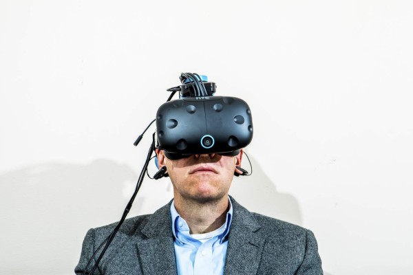 Cade Metz of The New York Times tests a Neurable headset that is part of the prototype for a game that lets users control actions with their thoughts, in San Francisco, July 7, 2017. The prototype is among the earliest fruits of a widespread effort to embrace technology that was once science fiction — and in some ways still is. (Christie Hem Klok/The New York Times)