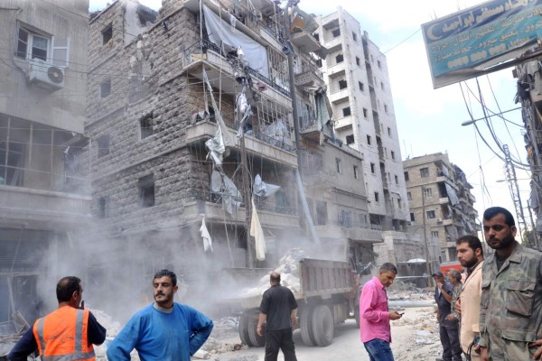 EDITORS NOTE: Graphic content / Syrians inspect the damage in the government-controlled side of the northern city of Aleppo following fighting between regime forces and rebels on April 28, 2016.The Syrian army was preparing an offensive to retake the whole of Aleppo, as fighting in the divided second city killed 38 civilians in a new blow for a tattered truce. Nearly 200 people have been killed in Aleppo in the past week as rebels have pounded government-held neighbourhoods with rocket and artillery fire and the regime has hit rebel areas with air raids. UN envoy Staffan de Mistura warned the hard-won February 27 ceasefire was now 'barely alive' and pleaded for urgent action by its cosponsors Russia and the United States to rescue it. But pro-government newspaper Al-Watan said the army was now poised for a 'decisive battle' for Aleppo and the surrounding province which would begin in the coming days. / AFP PHOTO / GEORGE OURFALIAN