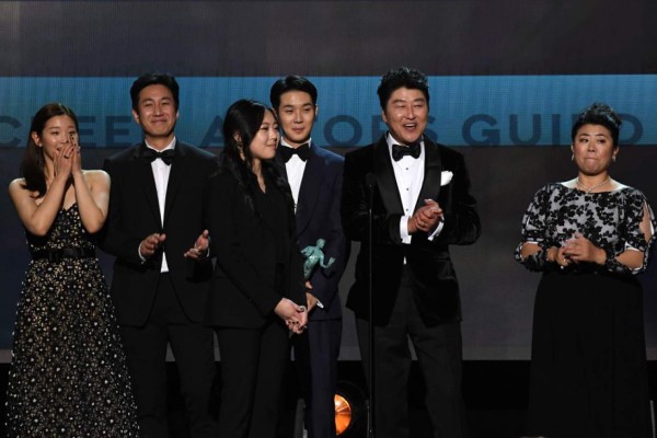 South Korean film director Bong Joon Ho (2nd -R) and the cast of 'Parasite' accept the award for Outstanding Performance by a Cast in a Motion Picture during the 26th Annual Screen Actors Guild Awards show at the Shrine Auditorium in Los Angeles on January 19, 2020. (Photo by Robyn Beck / AFP)