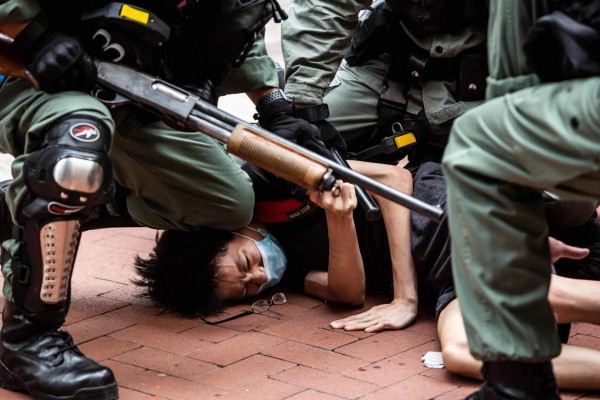 TOPSHOT - Pro-democracy protesters are arrested by police in the Causeway Bay district of Hong Kong on May 24, 2020, ahead of planned protests against a proposal to enact new security legislation in Hong Kong. - The proposed legislation is expected to ban treason, subversion and sedition, and follows repeated warnings from Beijing that it will no longer tolerate dissent in Hong Kong, which was shaken by months of massive, sometimes violent anti-government protests last year. (Photo by ISAAC LAWRENCE / AFP)