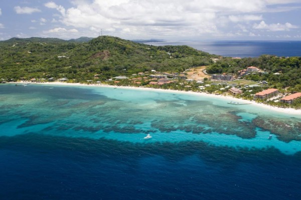 Aerial view of West Bay Beach and coral reefs visible off-shore. Roatan, Honduras