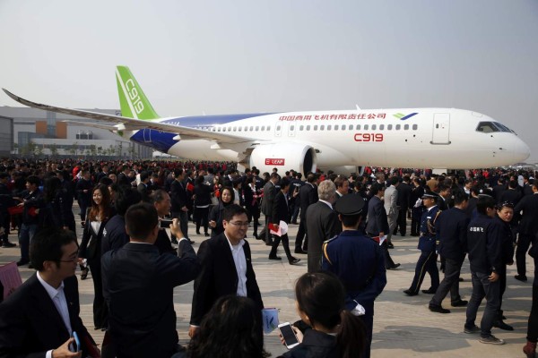 (FILES) This file photo taken on November 2, 2015 shows China's first big passenger plane, the C919, on display at a facility in commercial hub in Shanghai. China is expected within days to carry out the maiden test flight of a home-grown passenger jet built to meet soaring Chinese travel demand and challenge the dominance of Boeing and Airbus. The C919, built by state-owned aerospace manufacturer Commercial Aircraft Corporation of China (COMAC), was set to take wing over Shanghai and could be cleared for takeoff as early as May 5, 2017, according to state media. / AFP PHOTO / STR / China OUT / TO GO WITH China-aviation-manufacturing, ADVANCER by Albee ZHANG