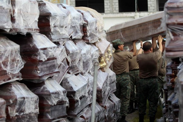 QUI01. PEDERNALES (ECUADOR), 20/04/2016.- Militares ecuatorianos custodian ataúdes para fallecidos en Pedernales (Ecuador) hoy, miércoles 20 de abril de 2016, en la zona afectada por el terremoto de 7,8 grados en la escala de Richter registrado el sábado en la costa norte de Ecuador. Un nuevo terremoto de 6,1 grados en la escala abierta de Richter sacudió hoy la costa norte de Ecuador, la misma zona afectada por el fuerte seísmo del sábado pasado, que mató a unas 500 personas. EFE/José Jácome