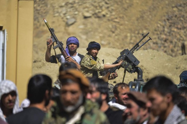 Afghan resistance movement and anti-Taliban uprising forces stand on the back of a pickup truck as they gather in Abshar district, Panjshir province on August 28, 2021. - Panjshir -- famous for its natural defences never penetrated by Soviet forces or the Taliban in earlier conflicts -- remains the last major holdout of anti-Taliban forces led by Ahmad Massoud, son of the famed Mujahideen leader Ahmed Shah Massoud. (Photo by Ahmad SAHEL ARMAN / AFP)