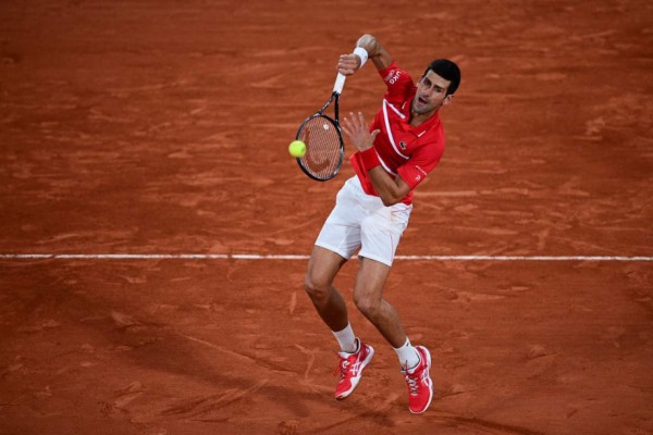 Serbia's Novak Djokovic returns the ball to Spain's Rafael Nadal during their men's final tennis match at the Philippe Chatrier court on Day 15 of The Roland Garros 2020 French Open tennis tournament in Paris on October 11, 2020. (Photo by MARTIN BUREAU / AFP)