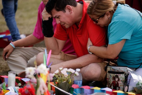 ORLANDO, FL - JUNE 14: Cesar Rodriguez (C), friend of Amanda Alvear who was killed in the shooting, is comforted by Lisa Dominguez (R) at a makeshift memorial at the Dr. Phillips Center for Performing Arts, June 14, 2016 in Orlando, Florida. The shooting at Pulse Nightclub, which killed 49 people and injured 53, is the worst mass-shooting event in American history. Drew Angerer/Getty Images/AFP== FOR NEWSPAPERS, INTERNET, TELCOS & TELEVISION USE ONLY ==