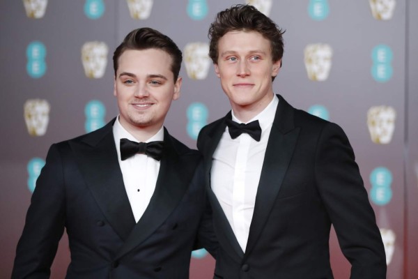 British actors Dean-Charles Chapman (L) and George MacKay (R) pose on the red carpet upon arrival at the BAFTA British Academy Film Awards at the Royal Albert Hall in London on February 2, 2020. (Photo by Tolga AKMEN / AFP)