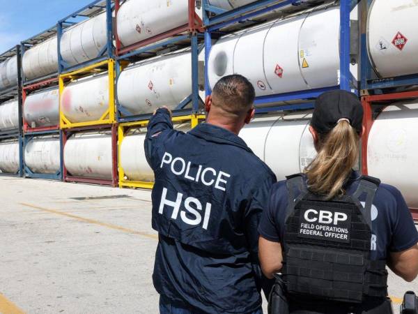 Fotografía divulgada por la Oficina de Investigaciones de Seguridad Nacional (HSI Miami), donde aparece uno de sus agentes, y una agente de la Oficina de Aduanas y Protección Fronteriza, observando algunos de los envíos de biodiésel incautados que, según se sospecha, estaban destinados a la exportación ilegal hacia una entidad cubana sancionada.