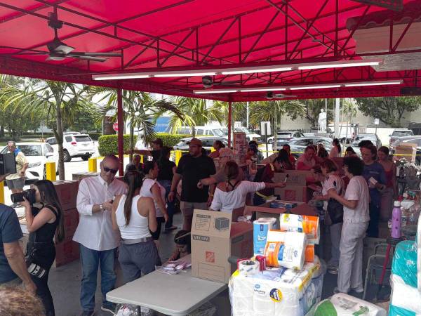 Personas asisten a una jornada de donación de alimentos y productos de higiene este viernes, en el restaurante venezolano 'El Arepazo' en Doral, Florida (Estados Unidos).