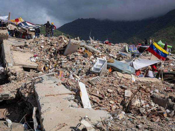 Voluntarios realizan labores de remoción de escombros de edificios destruidos por terremotos en Caraballeda (Venezuela).