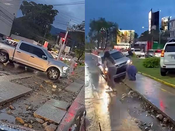 Varios vehículos quedaron atascados en las zanjas abiertas en el bulevar Los Próceres, en San Pedro Sula.