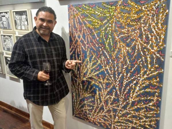 El artista hondureño Jaime Vallardo Chávez mostrando uno de sus cuadros.