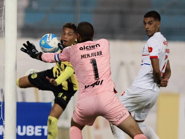 El portero Edrick Menjívar desvía el balón tras cabezazo realizado por el brasileño Moura de Real España.