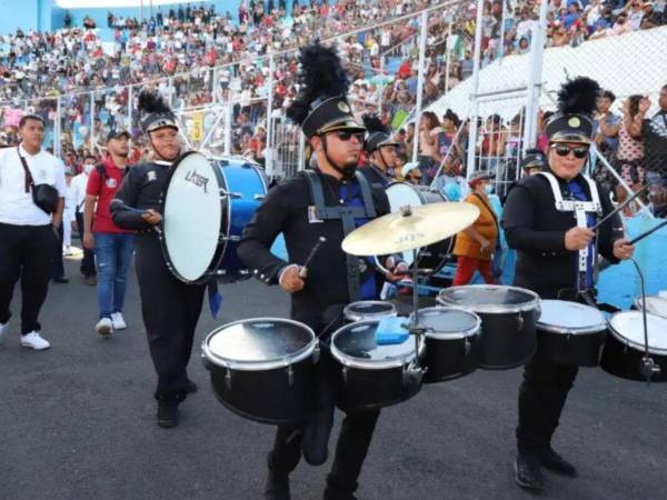 Fotografía de bandas colegiales participando en desfiles patrios.