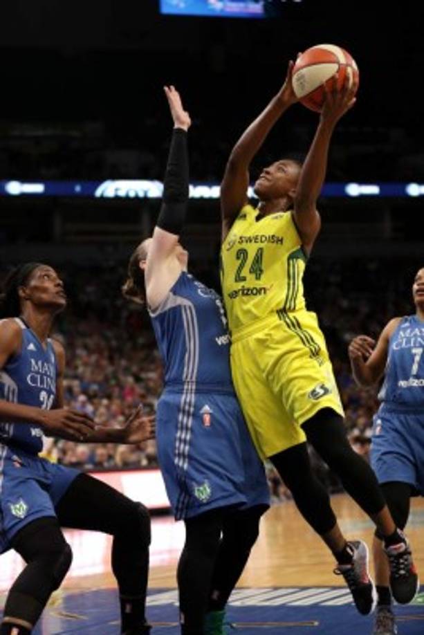 Base jumpers leap from the 300-metre high skydeck of Malaysia's landmark Kuala Lumpur Tower against the backdrop of the city's skyline on October 3, 2016 during the annual International KL Tower Base-Jump event. / AFP PHOTO / MANAN VATSYAYANA