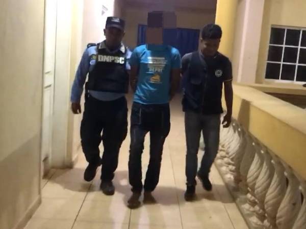 El detenido es custodiado por agentes de la Policía.