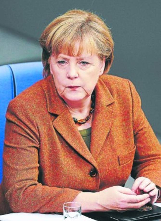 German Chancellor Angela Merkel attends a meeting of the German Federal Parliament, Bundestag, in Berlin, Germany, Wednesday, Dec. 12, 2012. German Parliament is expected to vote on legislation clarifying the legality of infant male circumcision for religious reasons. The government drew up the legislation after a court in June ruled the practice could amount to criminal bodily harm ? prompting outrage in Germany's Jewish and Muslim communities. (AP Photo/Michael Sohn)