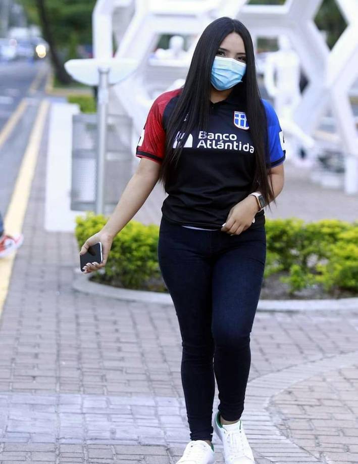 Una aficionada del Olimpia caminando por la Plaza Mundialista que está afuera del estadio Morazán.