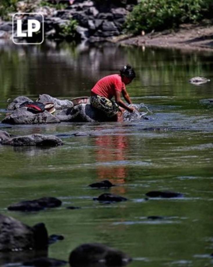 Lo hermoso de nuestros pueblos; a plena tarde, esta humilde hondureña lava la ropa en compañía de un fuerte sol,el cual no la detiene.